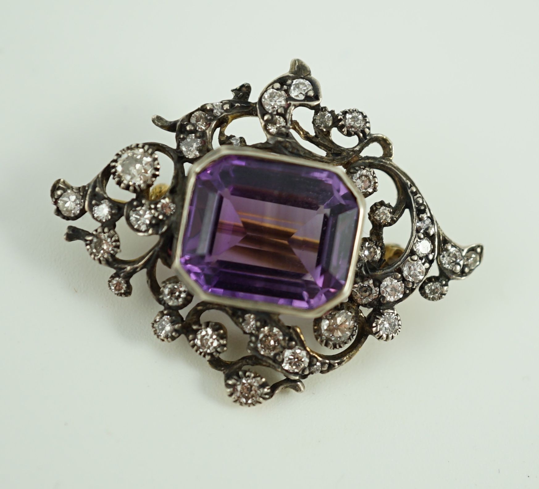 A Victorian gold and silver, emerald cut amethyst and diamond cluster set brooch